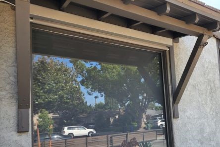 Exterior photo showing the automated window shades fully open, demonstrating visibility and sunlight control for South Pasadena installation